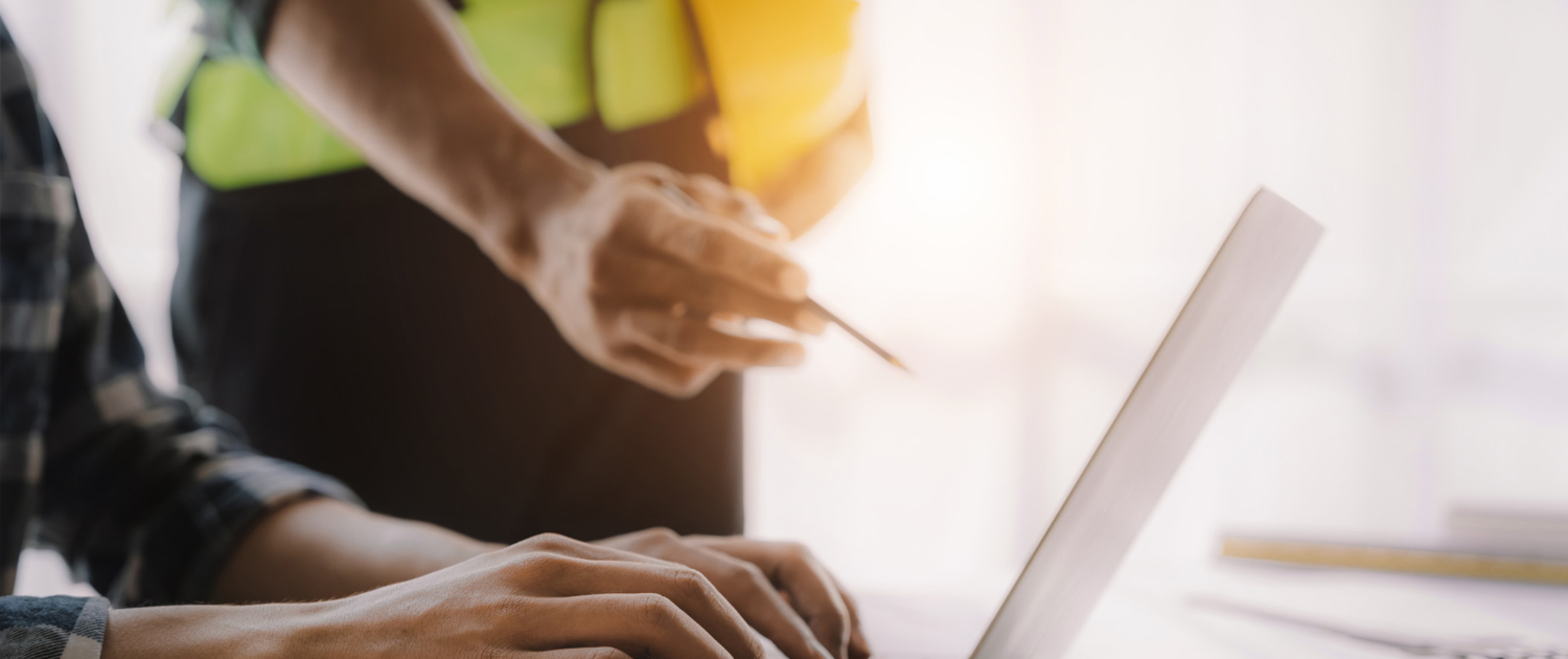 business man hand working and laptop with on on architectural