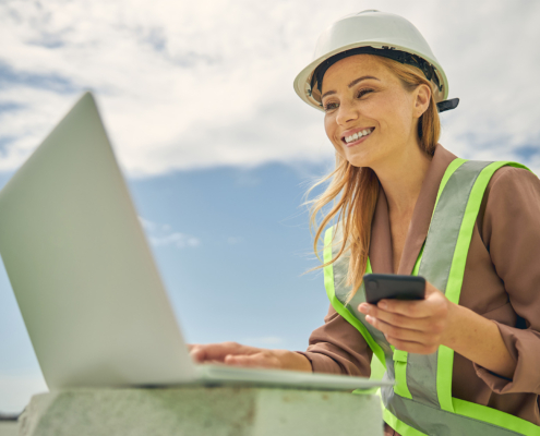 Joyful female engineer staring at her computer monitor