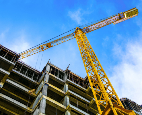 Worm's eye view of a crane in construction site