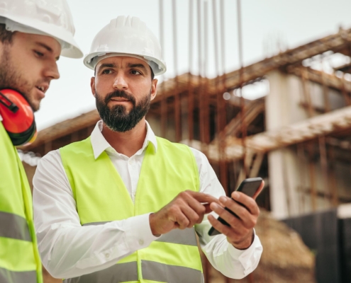 Construction worker using mobile device