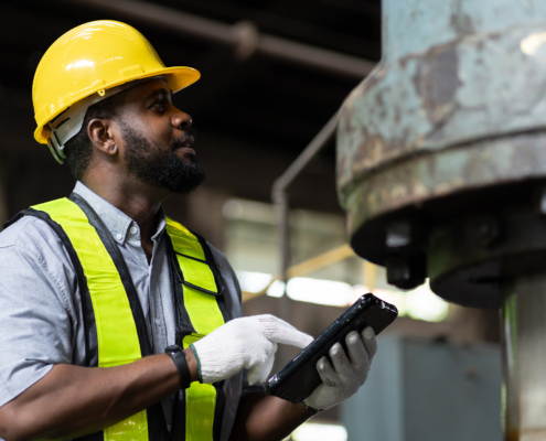 Side view of mechanical engineer looking at equipment