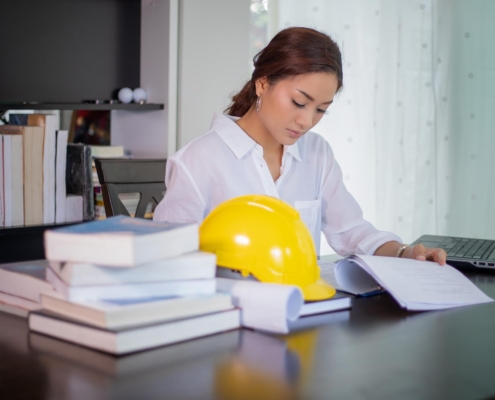 Construction worker looking at paperwork at desk