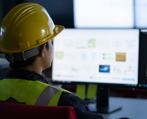 Industrial Engineering works in front of monitoring screen in the production control center